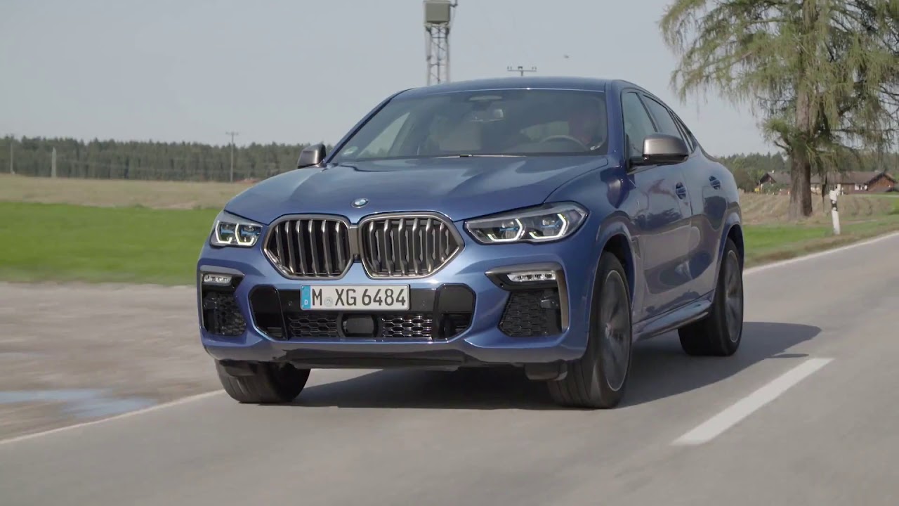 The new BMW X6 M50i Driving in the country