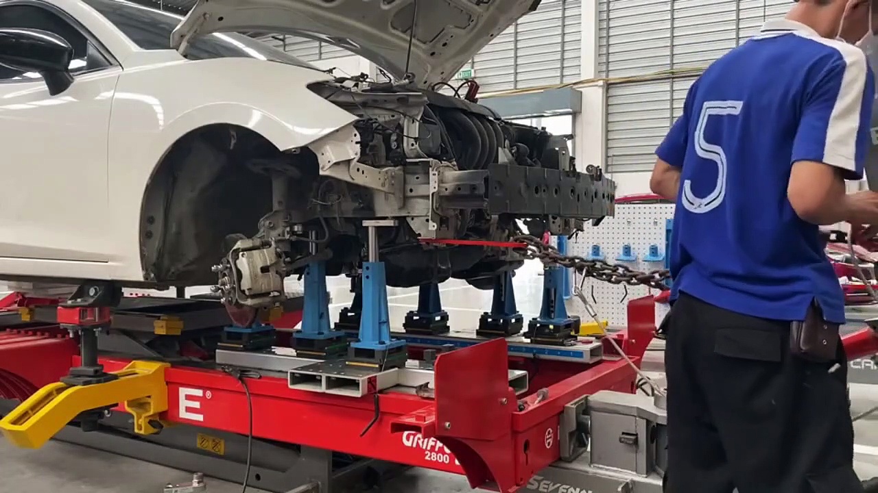 Mazda 3 frame straightening on job repair training with Celette car frame machine and pulling tower